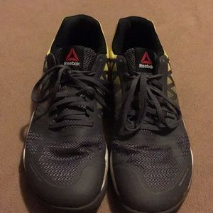 Men’s gray and yellow Reebok tennis shoes